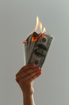 hand holding burning money
