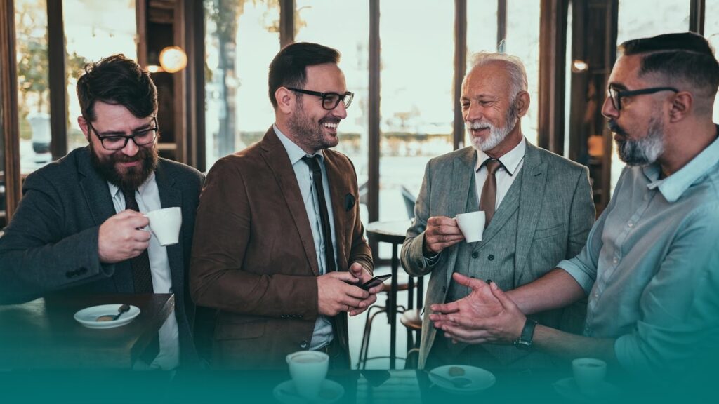 A group of real estate investors chatting over coffee