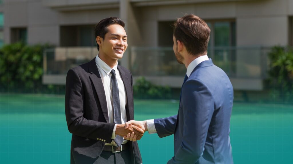 two real estate professionals shaking hands